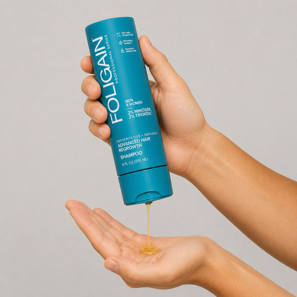 FOLIGAIN Advanced Hair Regrowth Shampoo with 2% Minoxidil, in hand, highlighting its ultra-pure formula for hair thinning support.