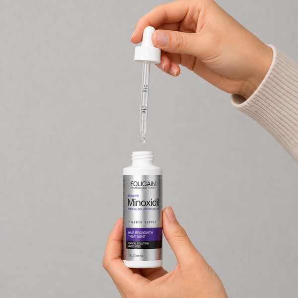 FOLIGAIN Canada women's Minoxidil 2% topical lotion bottle for hair regrowth treatment, 6-month supply, with applicator nozzle visible.