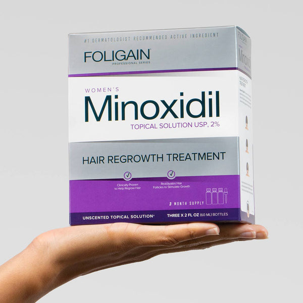 FOLIGAIN Ultra-Pure Minoxidil 2% hair regrowth topical lotion for women, shown in a bottle with applicator.