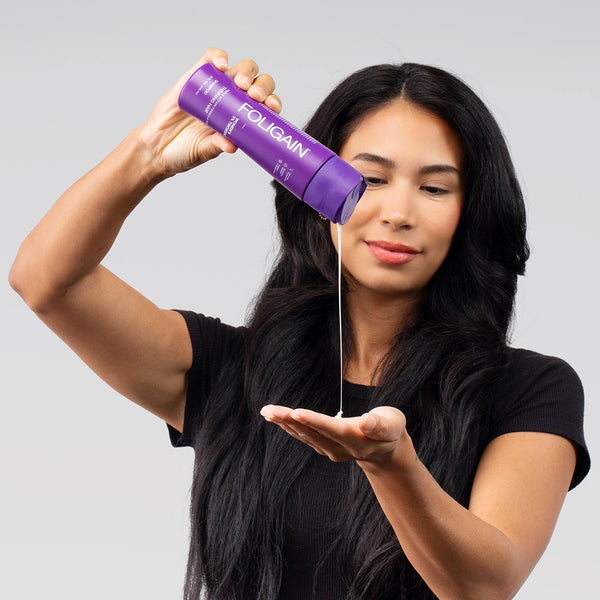 FOLIGAIN Triple Action Shampoo for thinning women’s hair with 2% Trioxidil, shown in a clear bottle with label, suitable for hair fall treatment.
